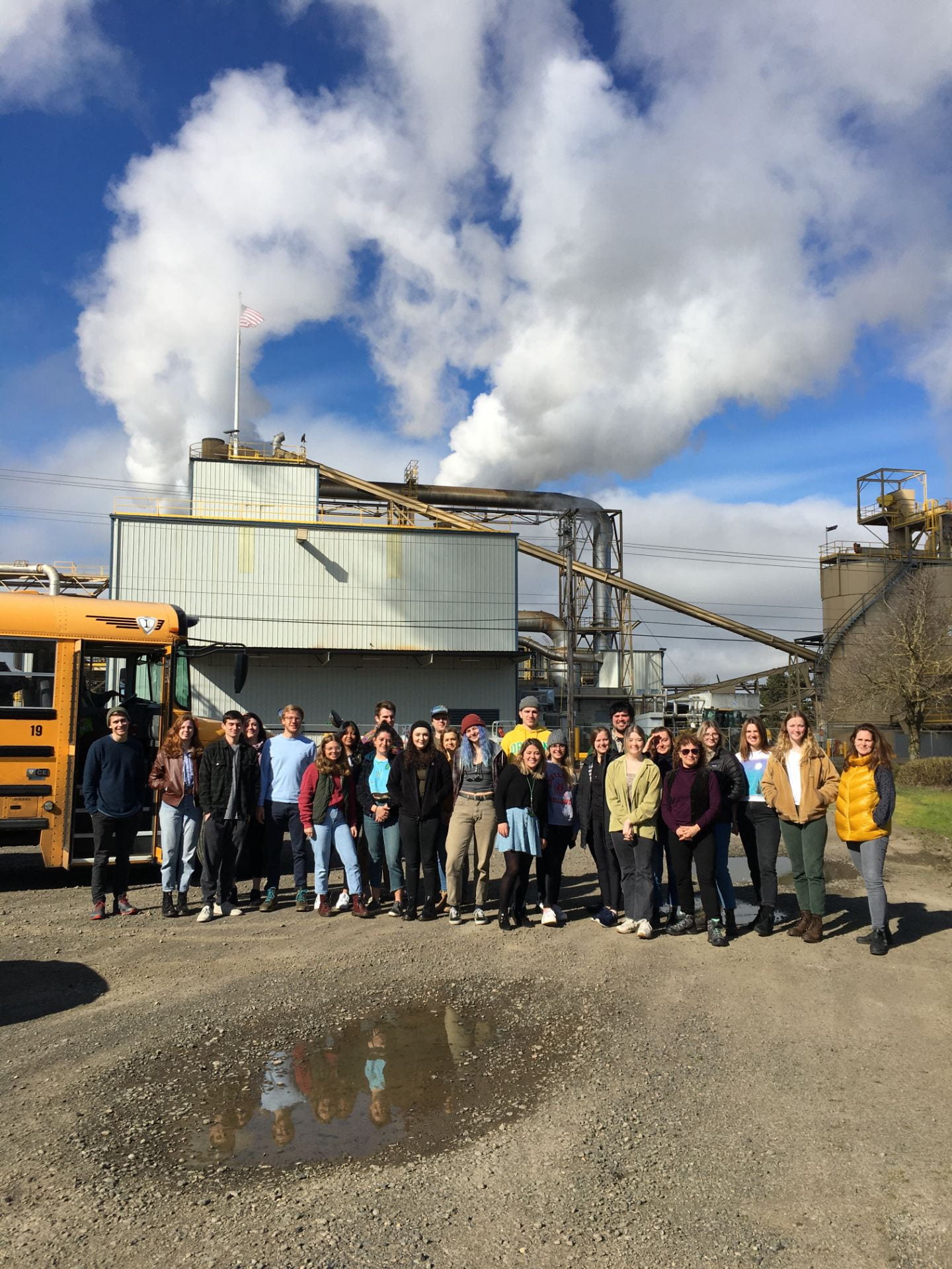 Group of students stand in front of industrial space in West Eugene
