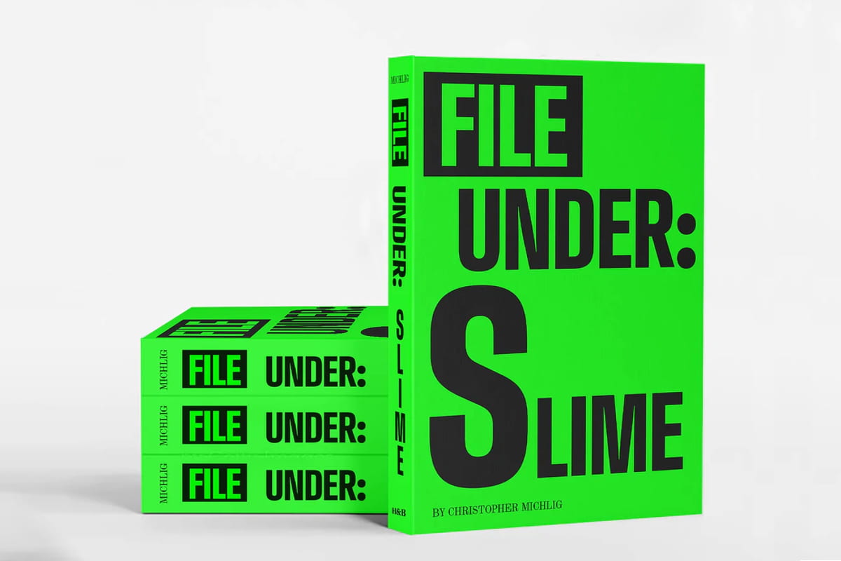 Stack of neon green books with one book upright with title cover facing forward.